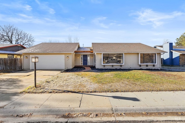 single story home featuring a front yard and a garage