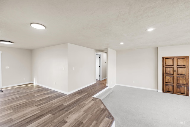 unfurnished room featuring a textured ceiling and hardwood / wood-style flooring