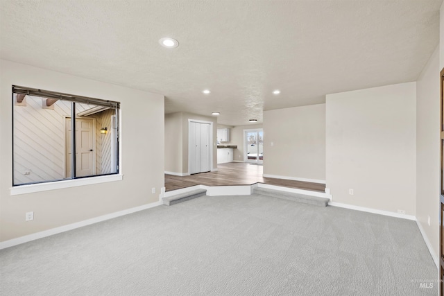 unfurnished living room with carpet