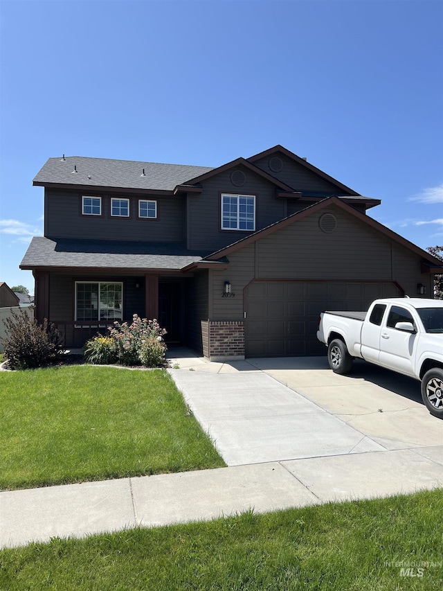 2059 Spring Creek Dr, Fruitland, ID 83619 - view of front of home with an attached garage, concrete driveway, and a front lawn
