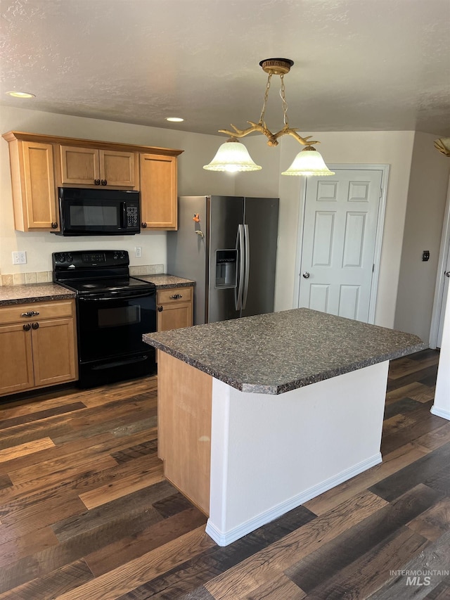 2059 Spring Creek Dr, Fruitland, ID 83619 - kitchen with black appliances, a center island, dark wood-type flooring, and dark stone counters
