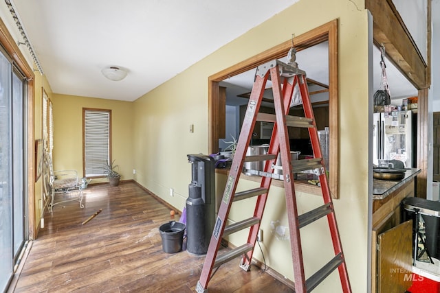 hall featuring baseboards and wood finished floors