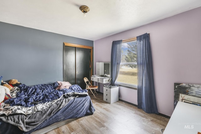 bedroom featuring a closet and light wood finished floors