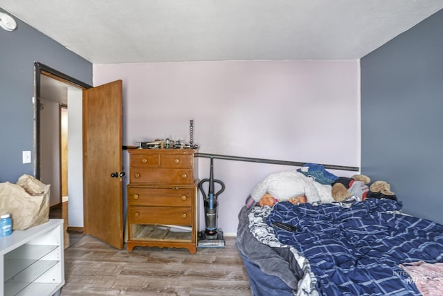 bedroom with wood finished floors