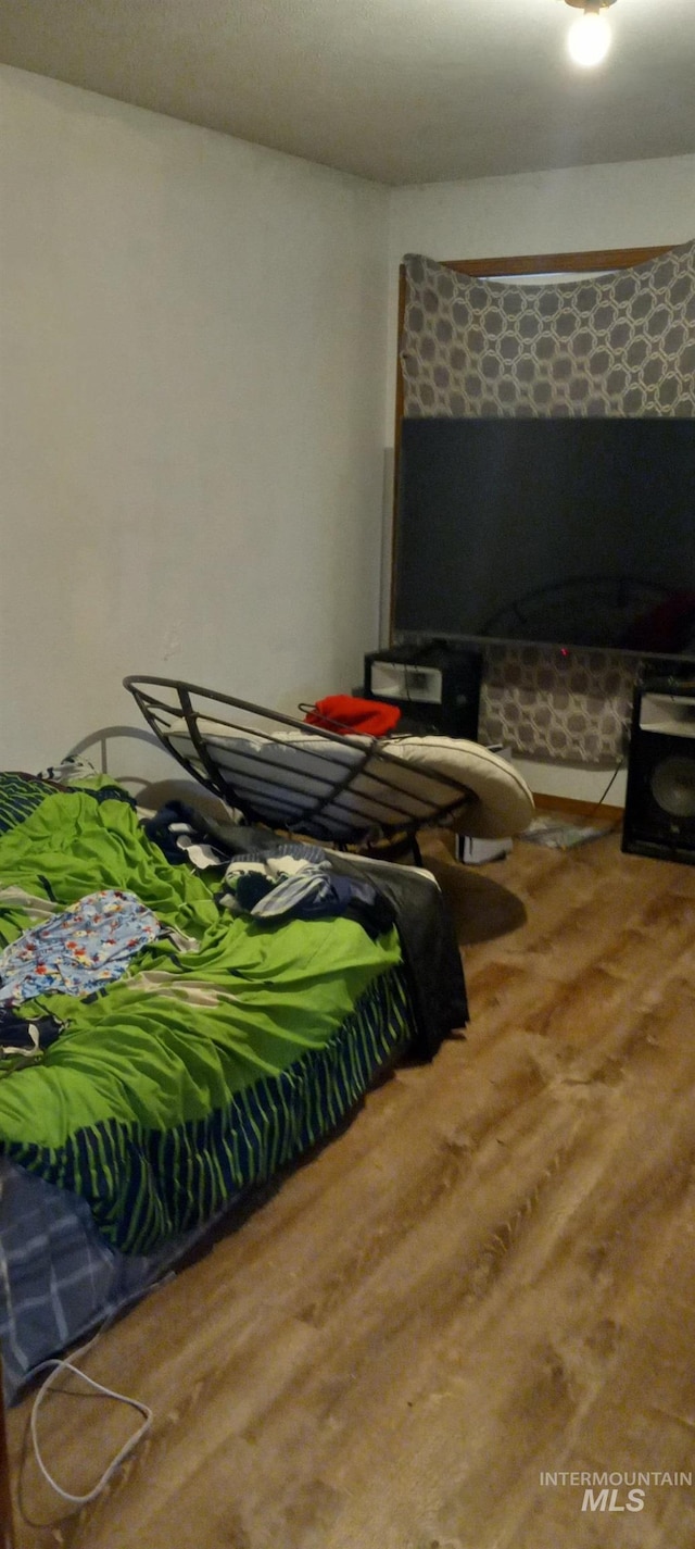 bedroom with wood finished floors