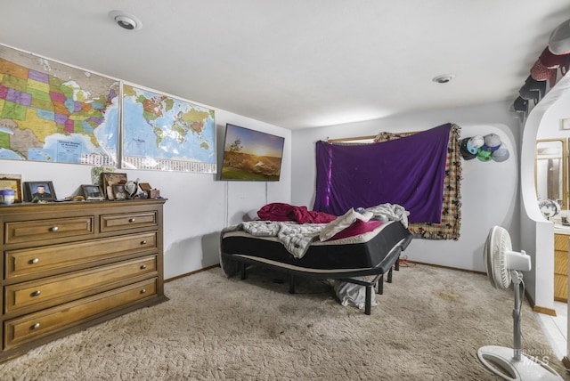 bedroom featuring light colored carpet and baseboards