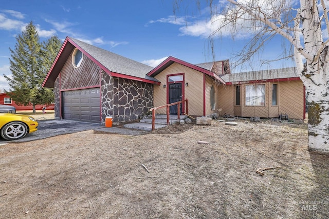 ranch-style house featuring driveway and an attached garage