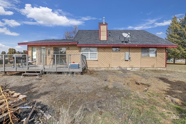 back of house featuring a deck and a chimney