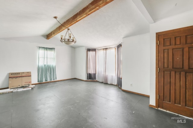 interior space featuring concrete flooring, lofted ceiling with beams, and baseboards