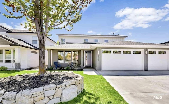 1765 E Bergeson St, Boise, ID 83706 - view of front facade with an attached garage, driveway, roof with shingles, and stucco siding