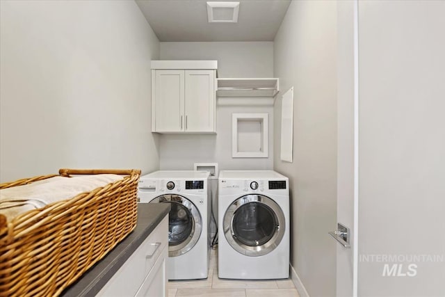1765 E Bergeson St, Boise, ID 83706 - laundry room featuring washing machine and dryer, cabinet space, light tile patterned floors, and baseboards