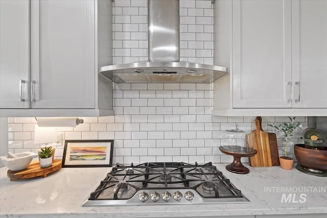 1765 E Bergeson St, Boise, ID 83706 - kitchen with wall chimney exhaust hood, stainless steel gas cooktop, tasteful backsplash, and light stone counters
