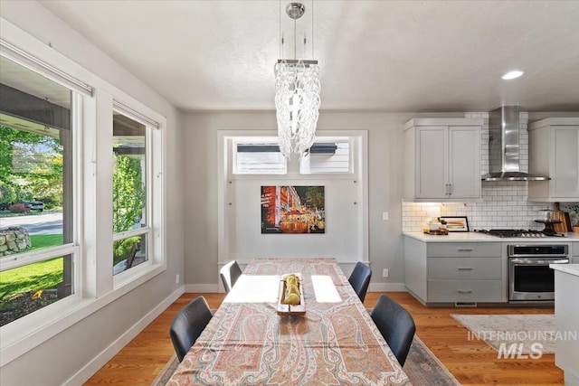 1765 E Bergeson St, Boise, ID 83706 - dining area with a chandelier, light wood-style flooring, baseboards, and recessed lighting