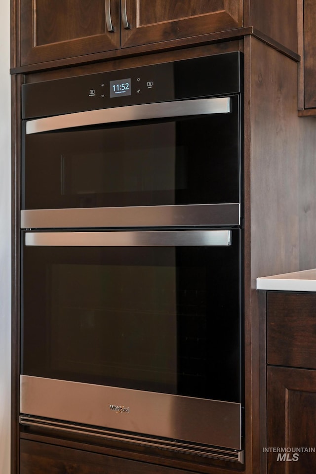 interior details featuring dark brown cabinetry and double oven