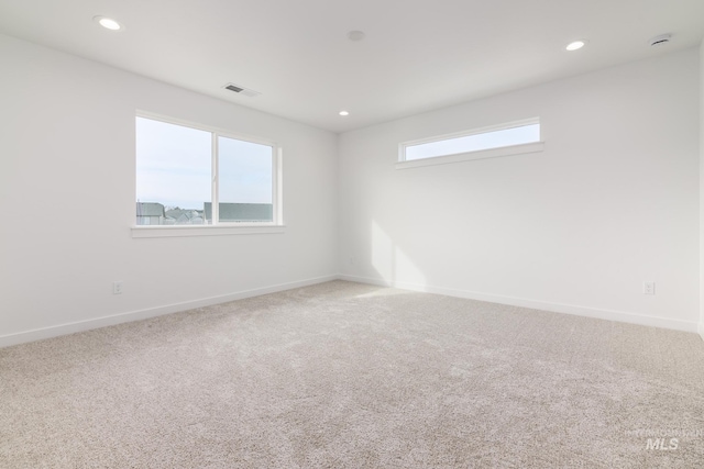 carpeted spare room with a healthy amount of sunlight