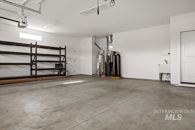 garage with gas water heater and a garage door opener