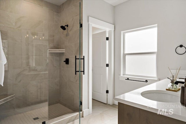 full bathroom featuring a shower stall, double vanity, and a sink