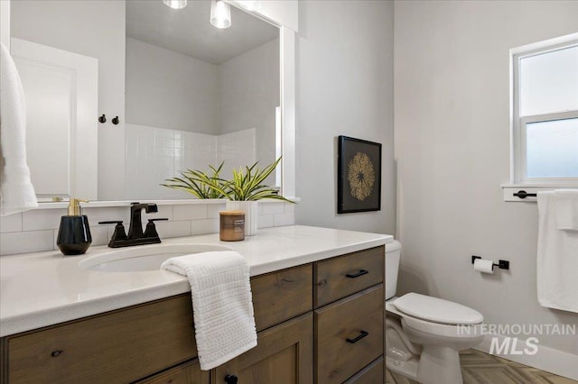 bathroom featuring toilet and vanity