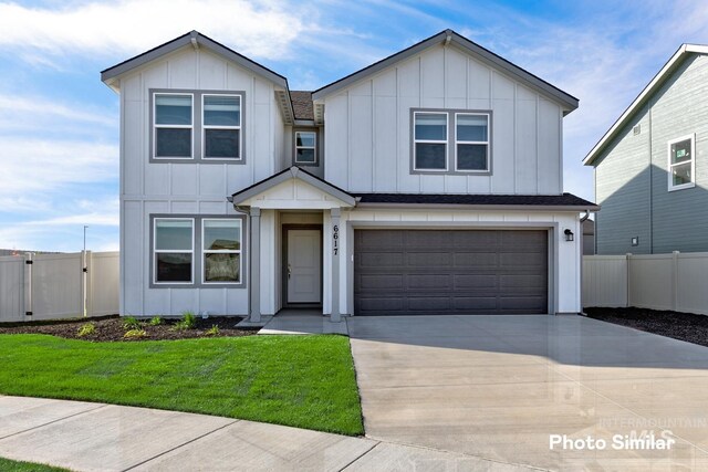 view of front of property featuring a garage and a front yard