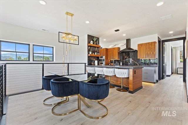 15 Alder Creek Ln, Garden Valley, ID 83622 - kitchen with wall chimney exhaust hood, dark countertops, open shelves, brown cabinetry, and modern cabinets