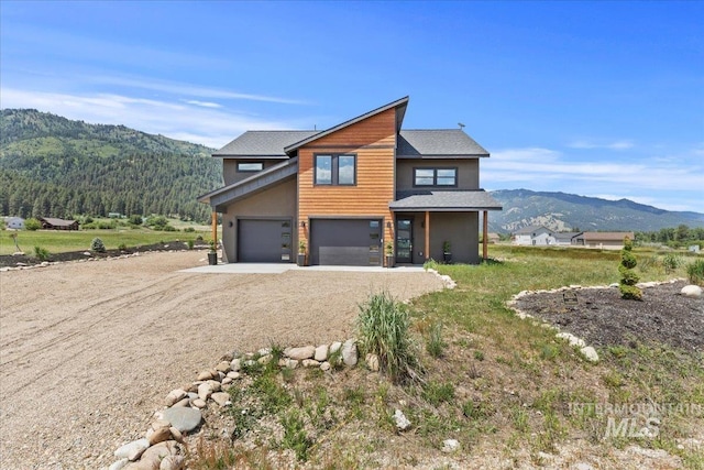 15 Alder Creek Ln, Garden Valley, ID 83622 - view of property exterior with a mountain view, dirt driveway, and a garage