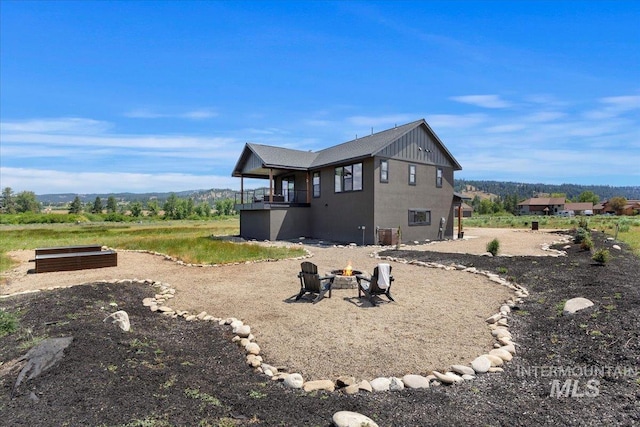 15 Alder Creek Ln, Garden Valley, ID 83622 - rear view of house featuring an outdoor fire pit and board and batten siding