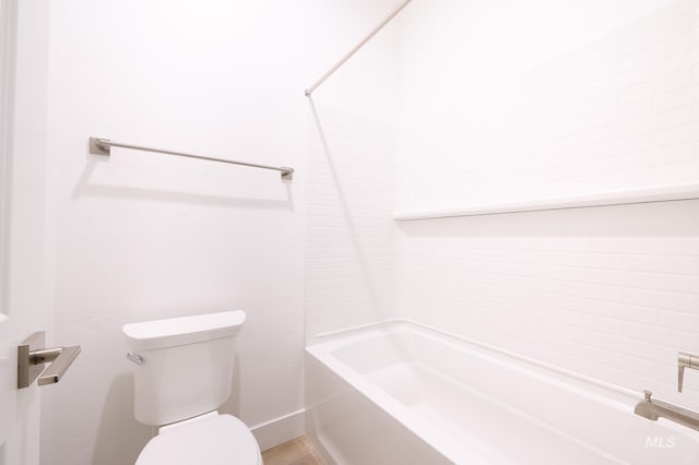 bathroom featuring toilet and bathtub / shower combination