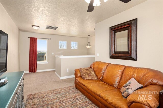 1375 Ross Rd, Weiser, ID 83672 - carpeted living room featuring a textured ceiling and a ceiling fan