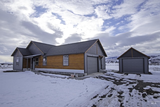 view of front of house with a garage and an outdoor structure