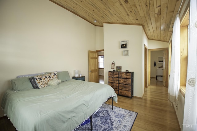 bedroom featuring lofted ceiling, wooden ceiling, crown molding, and wood finished floors