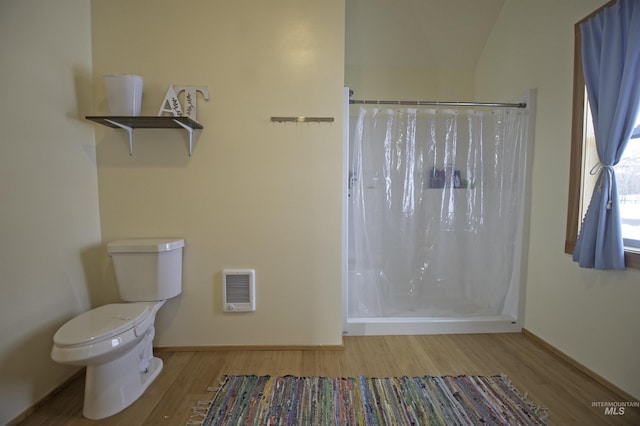 bathroom with a shower with curtain, baseboards, toilet, and wood finished floors