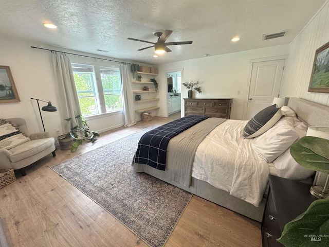 4446 S Carina Way, Meridian, ID 83642 - bedroom with wood finished floors, a textured ceiling, and a ceiling fan
