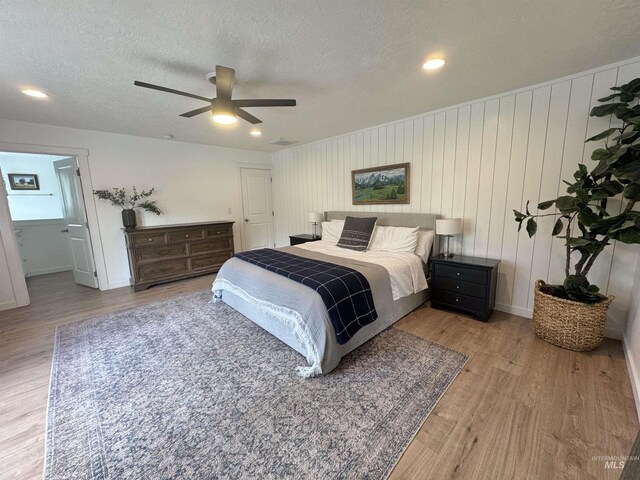 4446 S Carina Way, Meridian, ID 83642 - bedroom featuring wood finished floors, a textured ceiling, a ceiling fan, baseboards, and recessed lighting