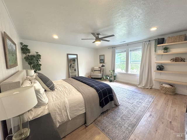 4446 S Carina Way, Meridian, ID 83642 - bedroom with wood finished floors, a textured ceiling, recessed lighting, ceiling fan, and baseboards