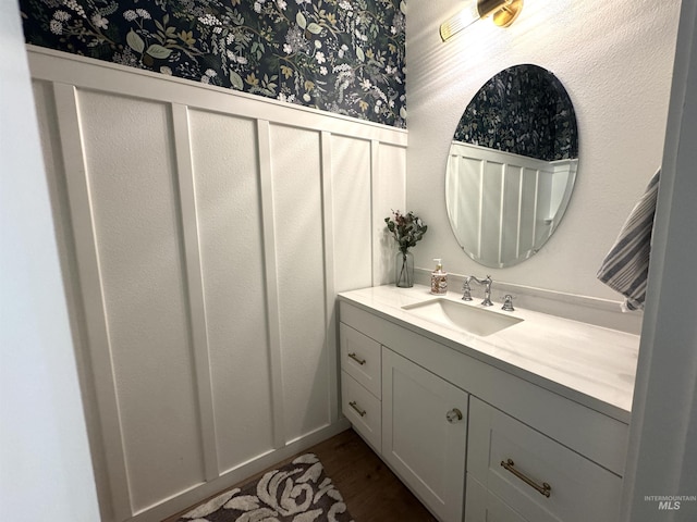 4446 S Carina Way, Meridian, ID 83642 - bathroom featuring wainscoting, wallpapered walls, vanity, and wood finished floors