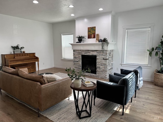 4446 S Carina Way, Meridian, ID 83642 - living area with recessed lighting, baseboards, wood finished floors, and a stone fireplace