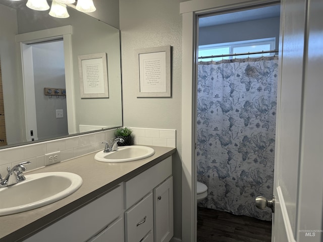 4446 S Carina Way, Meridian, ID 83642 - bathroom featuring backsplash, toilet, wood finished floors, double vanity, and a shower with shower curtain
