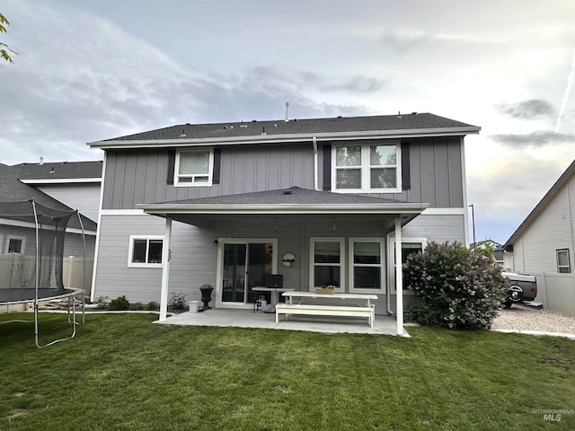 4446 S Carina Way, Meridian, ID 83642 - back of house featuring a trampoline, a patio, and board and batten siding
