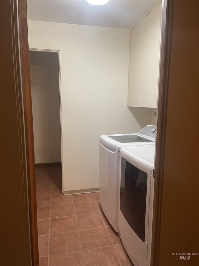 833 N Cleveland St, Moscow, ID 83843 - laundry room featuring separate washer and dryer, light tile patterned floors, and cabinet space