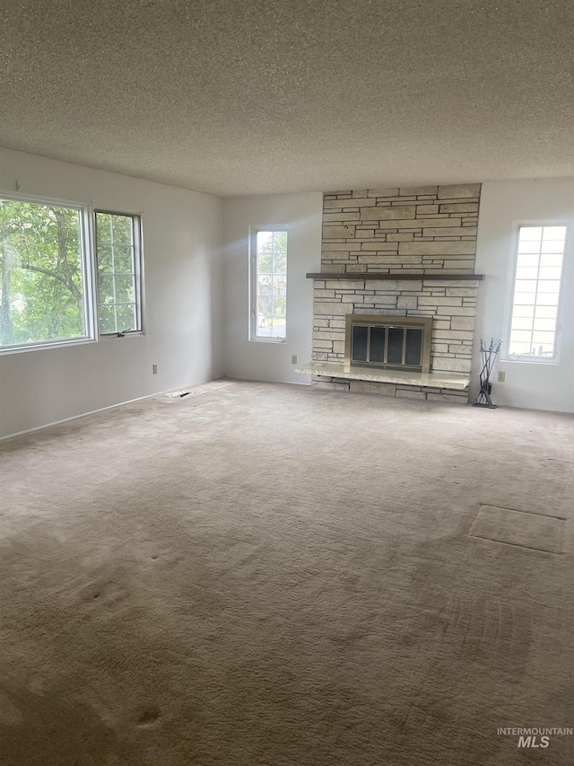 833 N Cleveland St, Moscow, ID 83843 - unfurnished living room with carpet, healthy amount of natural light, a textured ceiling, and a fireplace