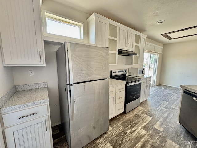 150 Sunset Dr N, Hagerman, ID 83332 - kitchen with stainless steel appliances, under cabinet range hood, wood finished floors, open shelves, and white cabinets