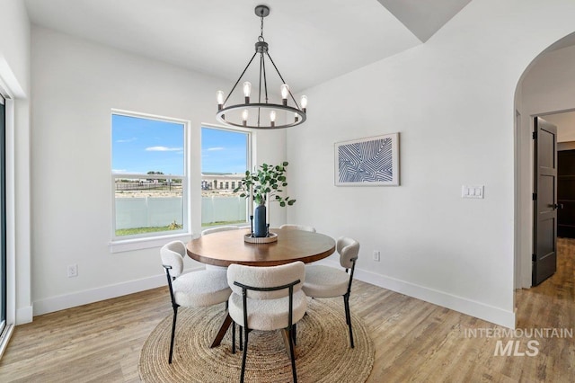 968 Gregory Way, Twin Falls, ID 83301 - dining room with arched walkways, a chandelier, and light wood finished floors