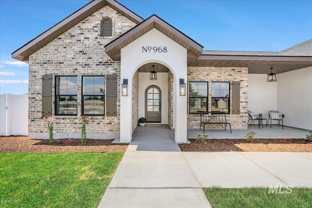 968 Gregory Way, Twin Falls, ID 83301 - property entrance with brick siding, a porch, and stone siding
