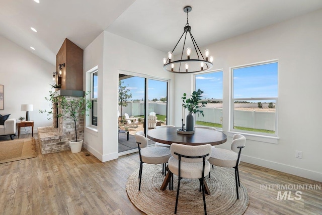 968 Gregory Way, Twin Falls, ID 83301 - dining area featuring a chandelier, light wood-style flooring, and lofted ceiling