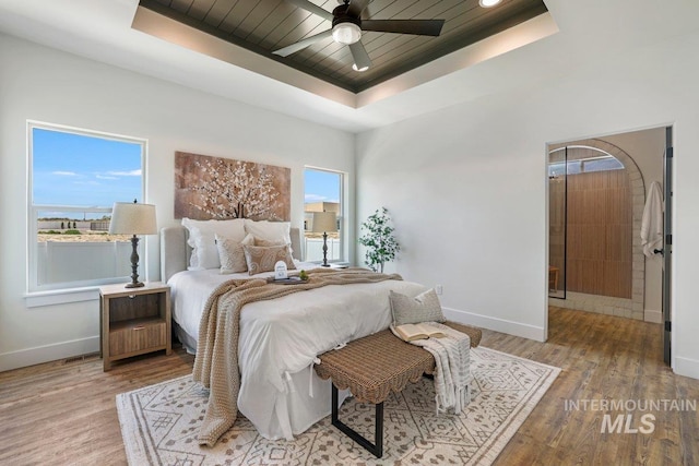 968 Gregory Way, Twin Falls, ID 83301 - bedroom featuring a tray ceiling, light wood-style flooring, wood ceiling, and a ceiling fan