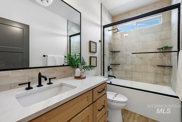 968 Gregory Way, Twin Falls, ID 83301 - bathroom with vanity, enclosed tub / shower combo, wood finished floors, and decorative backsplash
