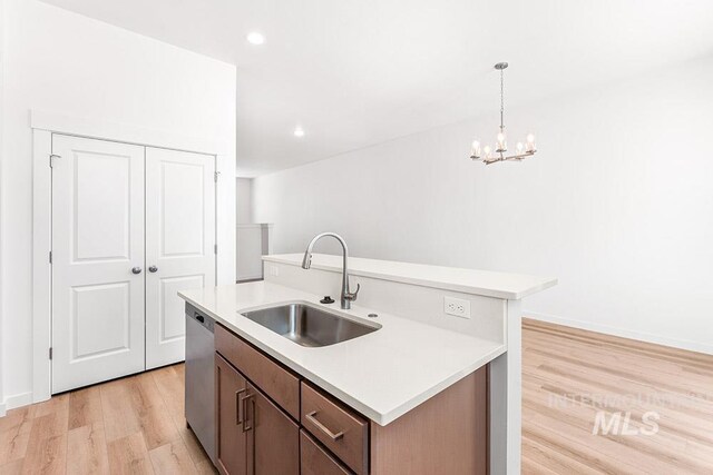 1609 N Impreza Ln Lot 24/1, Boise, ID 83713 - kitchen featuring a sink, dishwasher, light wood-style floors, a center island with sink, and light countertops