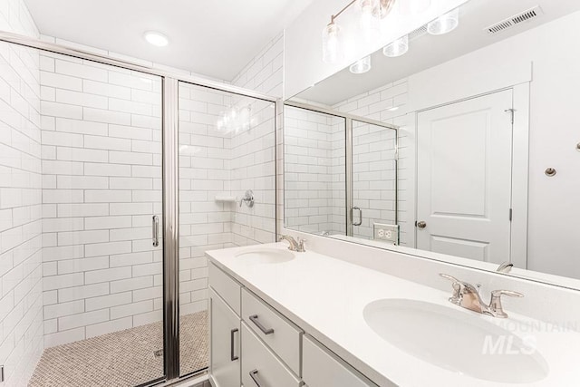 1609 N Impreza Ln Lot 24/1, Boise, ID 83713 - bathroom with a shower stall, double vanity, and recessed lighting