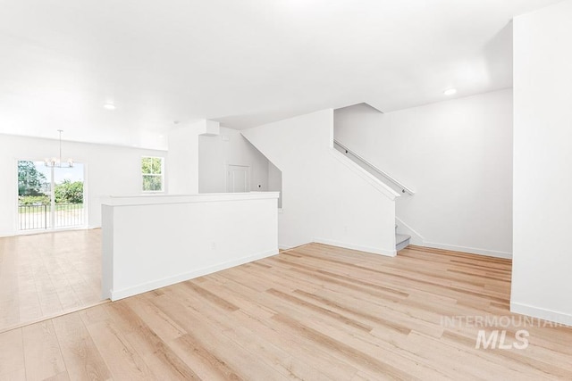1609 N Impreza Ln Lot 24/1, Boise, ID 83713 - unfurnished living room featuring a chandelier, light wood finished floors, baseboards, recessed lighting, and stairs