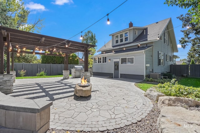 back of house featuring an outdoor fire pit, cooling unit, fence, a pergola, and a patio area